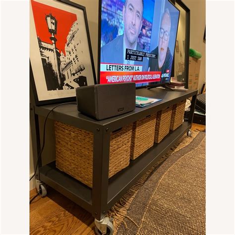 There is a light scratch on top from my toddler that is barely noticeable and some scratches on the back from bad movers, but if it's against the wall you'll never see it. . Cb2 tv stand